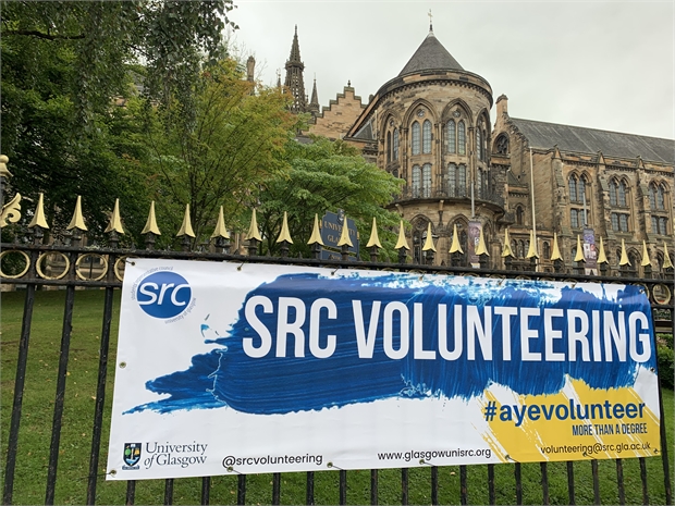 banner on railings reading SRC volunteering with university of glasgow in the background