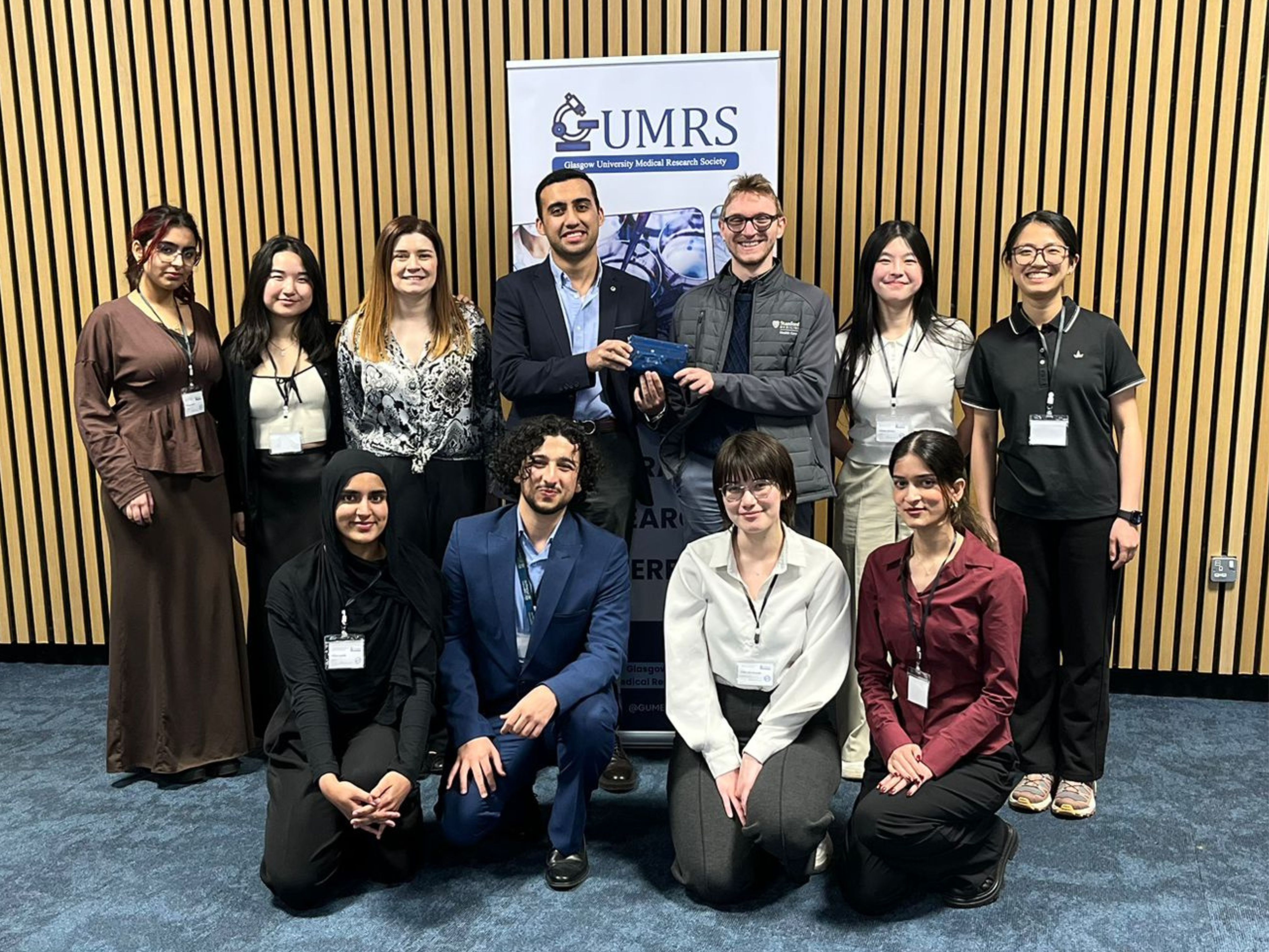 Students gathered outside in front of banner from the Medical Research Society as they hosted the 14th National Undergraduate Research Conference.